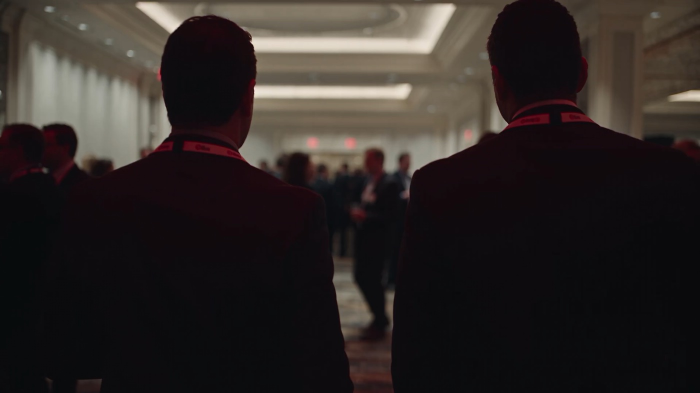 Two attendees entering a conference hall.